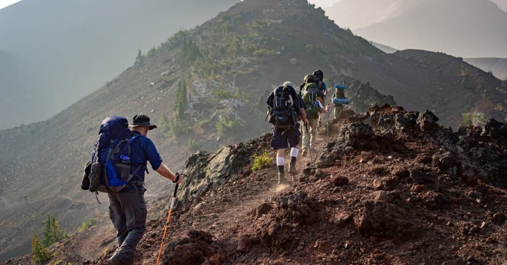 Group of hikers trekking on a rugged mountain trail in Oregon's scenic outdoors.