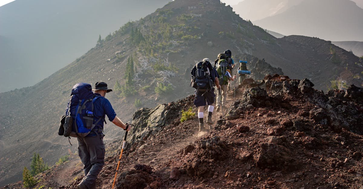 Group of hikers trekking on a rugged mountain trail in Oregon's scenic outdoors.