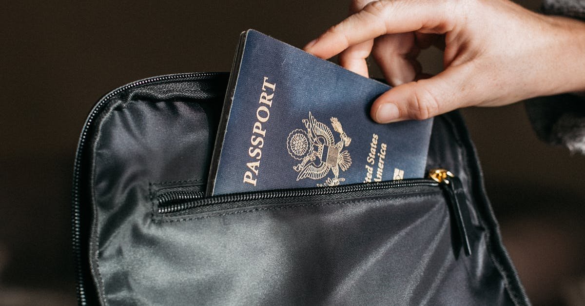 Close-up of a person placing a passport into a leather bag, ready for travel.
